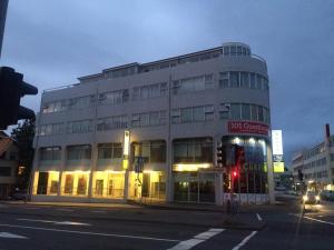 a building on the corner of a street with a traffic light at 101 Guesthouse Hotel in Reykjavík