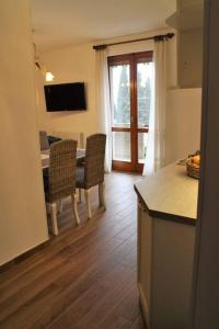 a kitchen and dining room with a table and chairs at Casa Carlotta in Tignale
