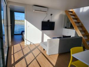 a living room with a staircase and a couch at Barcos Casa Aveiro in Aveiro