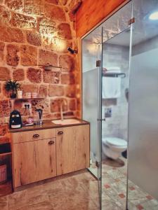 a bathroom with a shower and a sink and a toilet at Shafika house in ‘Akko