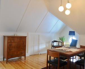 an attic dining room with a table and chairs at Napier House in Campbellton