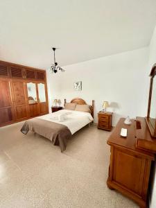 1 dormitorio con cama, tocador y mesa en Casa Los Jameos en Punta de Mujeres