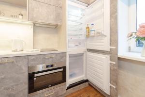 a kitchen with an open refrigerator with its door open at G11 Old Riga in Riga