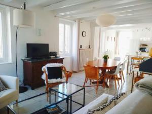 a living room with a table and a dining room at La Maison de Thuy - Gîte en Auvergne in Gimeaux