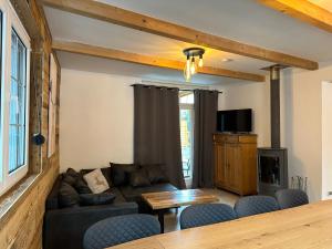 a living room with a couch and a table at Chalet Ferienhaus Dresden in Dresden