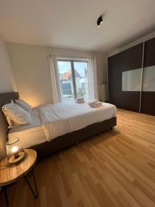a bedroom with a bed and a large window at Antwerp City Appartment in Antwerp