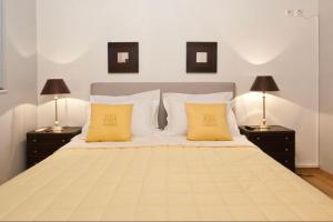 a bedroom with a large bed with yellow pillows at Luxury Acropolis View Duplex Penthouse in Thiseio 155m2 in Athens