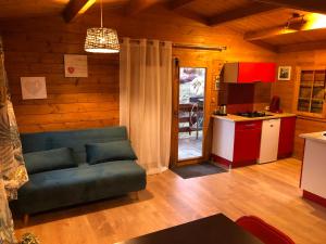 a living room with a couch and a kitchen at Les Chalets De Lozzi in Calacuccia