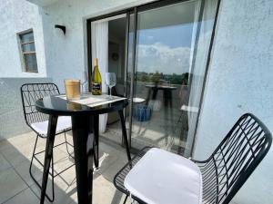 a table and chairs on a balcony with a window at Large 1 bedroom apartment with free private parking in Miami Beach