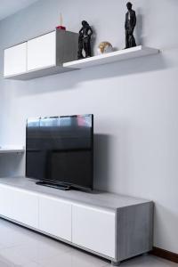 a tv sitting on top of a white entertainment center at PISO MODERNO COMPLETO LOVE MARIN 2 in Marín