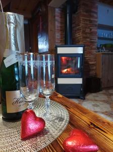 a table with two glasses and a bottle of wine at Chata Evka in Ružomberok +15 photos