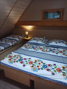 Una cama con flores en una habitación en Chata Evka, en Ružomberok