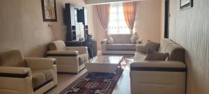 a living room with a couch and chairs and a table at Güngören Hotel in Kars