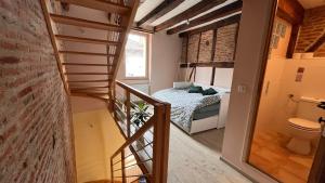 a small room with a staircase leading to a bedroom at Le Gite d Eugenie in Gaillac