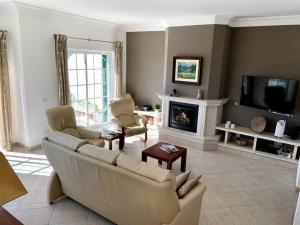 a living room with a couch and a fireplace at Villa Hermano with views and private pool in Lagos