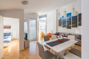 a white dining room with a white table and chairs at DREAM & RELAX Apartment in Bohinj