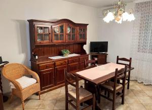 a dining room with a table and a wooden cabinet at CASA GIULIETTA in Tolle