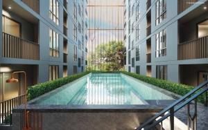 a swimming pool in the middle of a building at Notthing Hill Charoenkrung93 Condominium in Godown