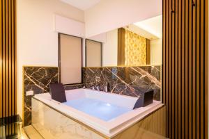 羅馬的住宿－AlbaDea Suites&Jacuzzi，带浴缸和镜子的浴室