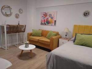 a bedroom with a bed and a couch and a table at Beautiful studio in Palermo in Buenos Aires