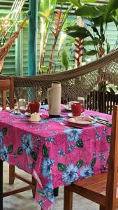 a table with a pink and blue table cloth on it at 4eTal Trancoso in Trancoso