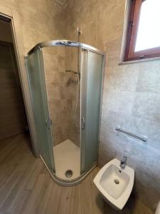 y baño con ducha, aseo y lavamanos. en Moderno trilocale a 20 metri dal mare en San Vincenzo