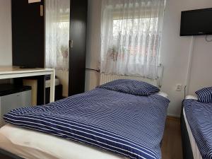 a bedroom with two beds and a window at Noclegi u Emilii in Sopot