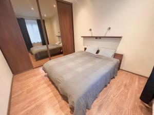 a bedroom with a bed and a large mirror at 2-room apartment in the city center in Poznań