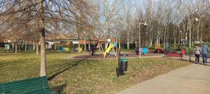 un parque con parque infantil con gente dentro en Rosaviola, en Vimodrone