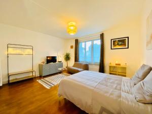 a bedroom with a bed and a living room at Le Joly Cocon-Proche mer-wifi-fibre in Saint-Nazaire