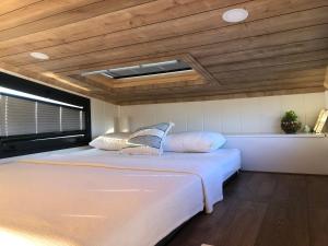 a bedroom with two beds and a ceiling at Zeytiny l Tiny Houses & Farm l Çeşme in Çeşme