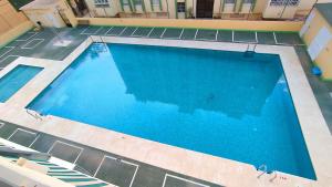 an overhead view of a large blue swimming pool at Alcazaba in Torre del Mar