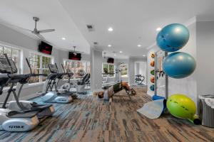 a fitness room with a man doing a push up in a gym at Truist Park Comfort Stays in Atlanta