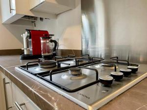 a stove top oven in a kitchen at Big Modern House - 15min to NEC - Sleeps 10 in Birmingham