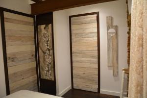 a bedroom with wooden sliding doors on the wall at Can Senio 1 in Tossa de Mar