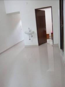 a white room with a sink and a door at Kalawati Niwas in Bodh Gaya