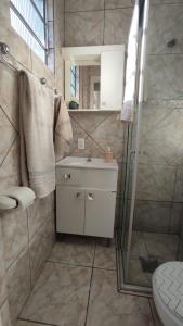 a bathroom with a shower and a sink and a toilet at Cidade Baixa Apart Studio Encantador in Porto Alegre