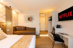 a hotel room with a bed and a couch at AlbaDea Suites&Jacuzzi in Rome