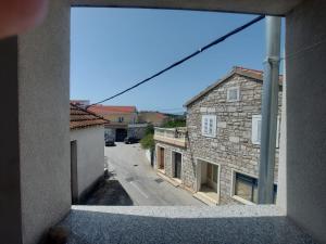 a view of a street from a window of a building at Apartments Božena in Pakoštane