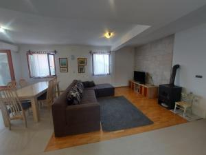 a living room with a couch and a dining room at Apartments Božena in Pakoštane