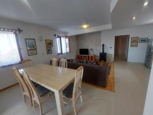 a dining room and living room with a table and chairs at Apartments Božena in Pakoštane