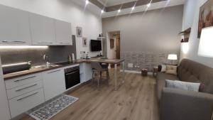 a kitchen and living room with a table and a couch at Marina Apartments in Catanzaro Lido