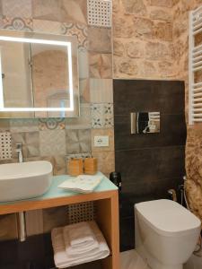 a bathroom with a sink and a toilet at Casa vacanze Modica Charme in Modica