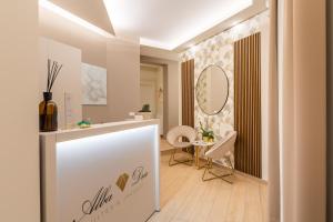 a dressing room with a counter and a mirror at AlbaDea Suites&Jacuzzi in Rome