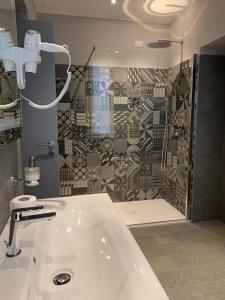 a bathroom with a sink and a shower with a shower at La Castellana Loft Hotel in Bergamo