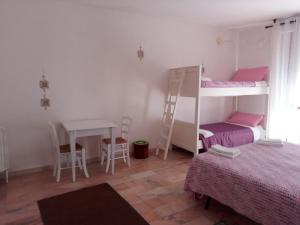 a room with two bunk beds and a desk at Shanel in Seravezza