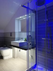 a bathroom with a sink and a shower and a toilet at Marina Apartments in Catanzaro Lido
