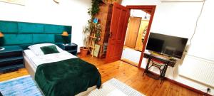 a bedroom with a bed and a flat screen tv at Apartament ze słoneczną werandą -250 m do plaży in Sopot