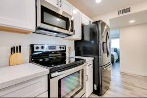 a kitchen with a stove and a refrigerator at Modern Villa in Old Litchfield in Litchfield Park