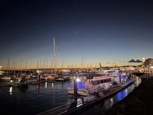 a boat docked at a marina at night at sea you later in Ponta Delgada